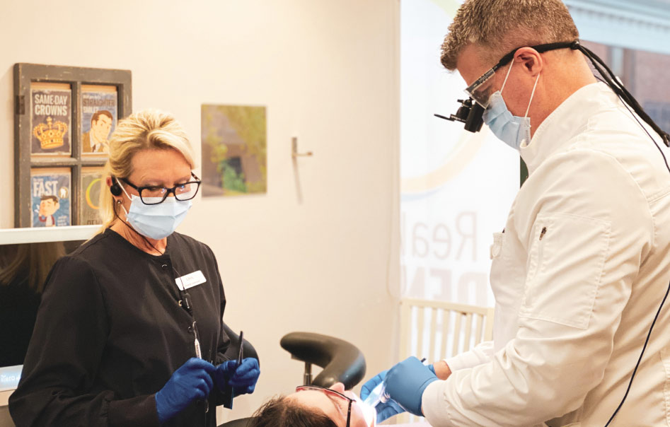 Hygienist cleaning and working alongside dentist